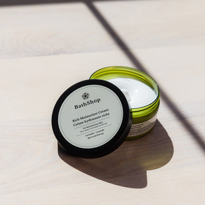 Jar of The Bath Shop rich moisturizer cream on a light surface with shadows