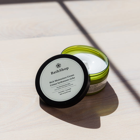 Jar of The Bath Shop rich moisturizer cream on a light surface with shadows